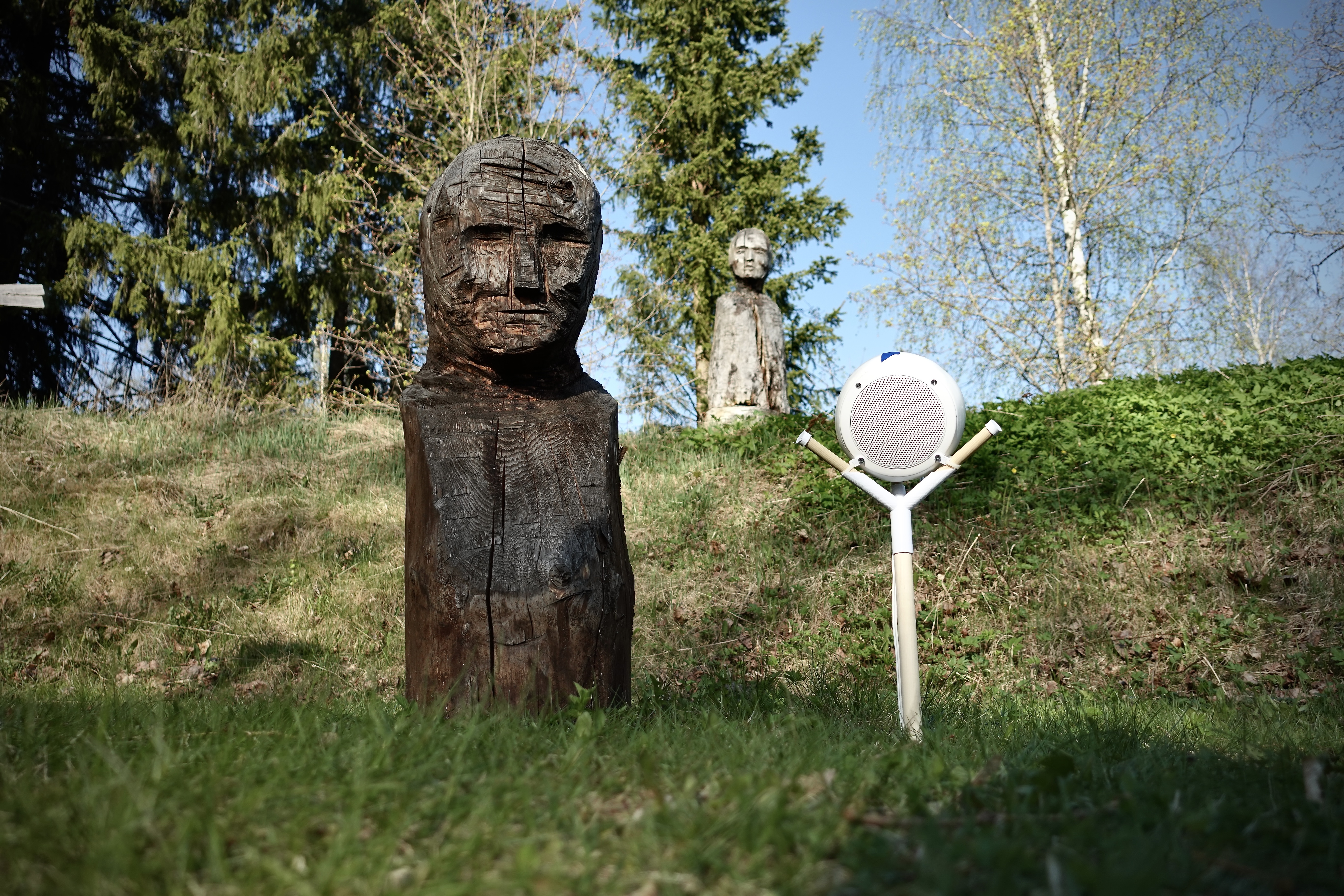 White loudspeaker beside Panu Ollikainen's Saattoväki installation at Haihatus amphitheatre