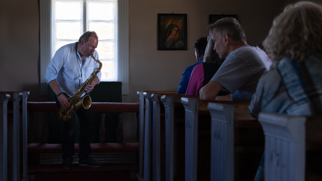 Saxophone performance inside Jurmo chapel during the opening programme of INTER, Jurmo. Photo: Joonas T. Laine